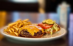 The Elvis Velveeta Burger with fries, served during 614 Burger & Beer Week 2024